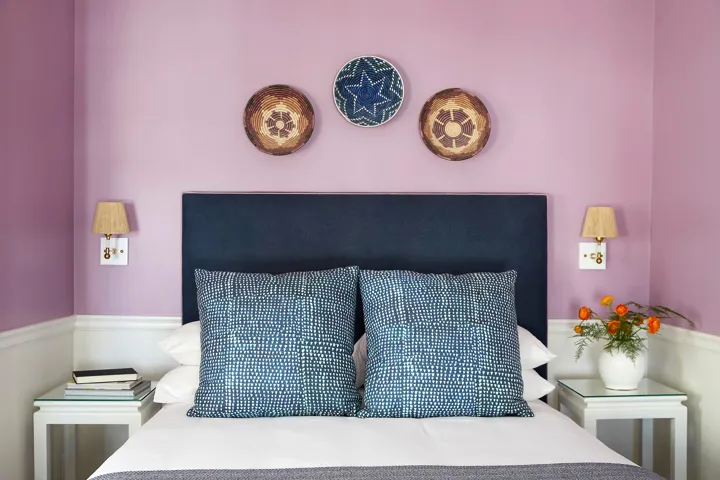 Queen bed with two side tables in a guest room at The Christopher