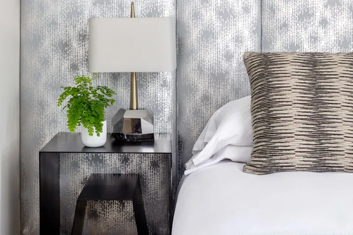 Close up of a side table and silver backsplash in a guest room at The Richard