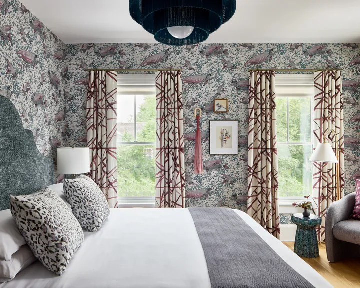 The Coastal Nook King guest room featuring fish patterned wallpaper